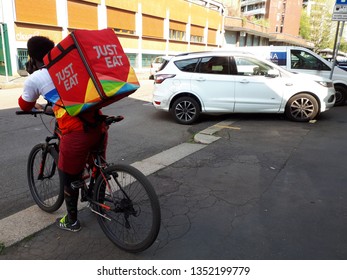 Just Eat Food Delivery Boy in the Street of Milan,Italy-March 2019