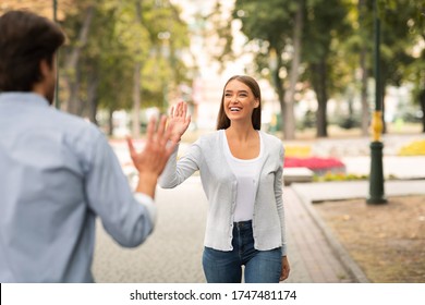 Just Friends. Girl Waving Hello Meeting Guy Walking In Park Outside. Selective Focus - Shutterstock ID 1747481174
