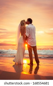 Just Married Couple Kissing On Tropical Beach At Sunset, Hawaii Beach Wedding, Intimate Loving Moment