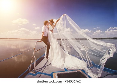 Just married couple on yacht. Happy bride and groom on their wedding day