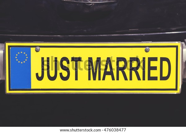 Just married euro license plate on retro wedding\
car. Vintage style.