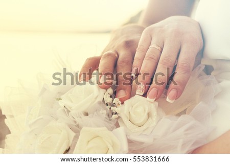 Just married hands together shows marriage rings