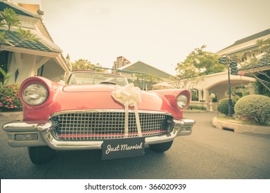 Just married sign with vintage wedding car. Cross Processed for vintage look