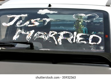 Just Married Written In Foam On The Back Of A Car Window