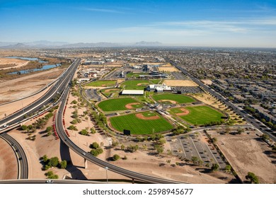 Just off the Loop 202 Freeway in Mesa, Arizona a professional baseball stadium and fields for practice and recreation viewed from west to east from above 
