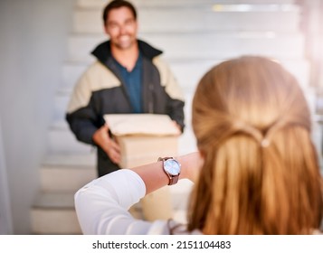 Just On Time. Shot Of A Businesswoman Checking The Time On Her Watch As The Courier Arrives With A Delivery.