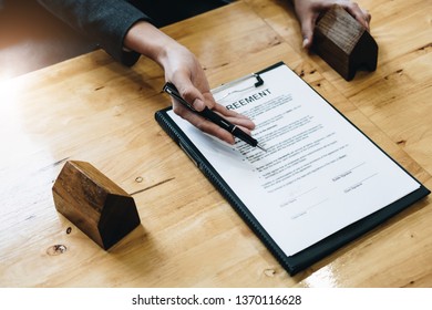 Just Put Your Signature Here! Cheerful Young Man Signing Some Documents