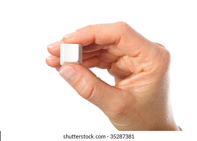 Just a small empty key from a computerkeyboard in hand, white background