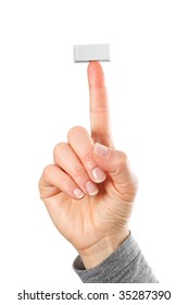 Just a small empty rectangular key from a computerkeyboard on fingertip of whole hand, white background