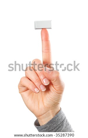 Just a small empty rectangular key from a computerkeyboard on fingertip of whole hand, white background