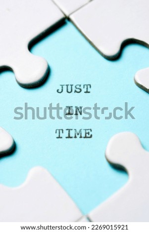 Just in time text written with a typewriter in a white puzzle