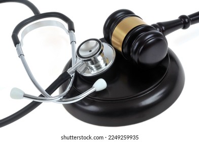 Justice and health concept with a stethoscope and a judge's gavel close up on a white background - Shutterstock ID 2249259935
