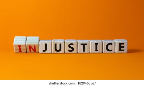 Justice instead of injustice. Turned cubes and changed the word 'injustice' to 'justice' on wooden cubes. Beautiful orange background, copy space. Business concept. - Shutterstock ID 1829468567