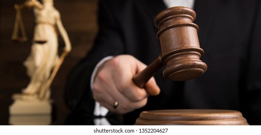 Justice and law concept, Male judge in a courtroom striking the gavel