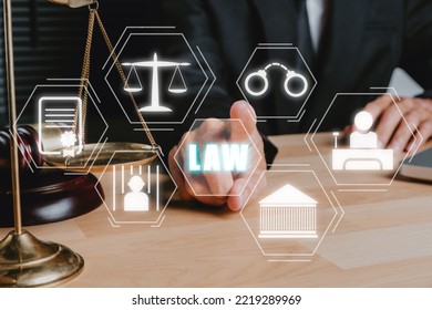 Justice And Law Concept, Male Judge Working On Laptop Computer With VR Screen Law Icon Background.