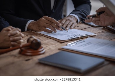 justice and law concept. male lawyer working in an office. Legal law, advice, and justice concept. The client is bringing the documents to clarify the law to the lawyer at the prosecutor's office.
 - Shutterstock ID 2298813341