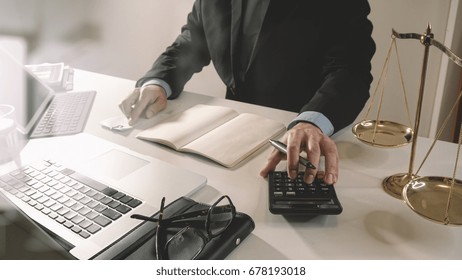 Justice And Law Concept.businessman Or Lawyer Or Accountant Working On Accounts Using A Calculator And Laptop Computer And Documents In Modern Office