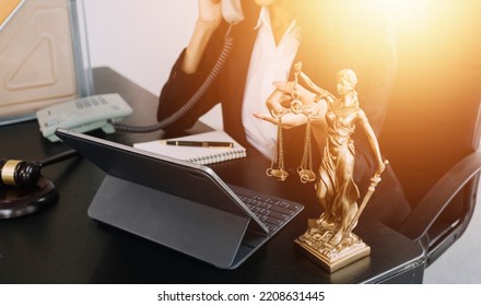justice and law concept.Male judge in a courtroom on wooden table and Counselor or Male lawyer working in office. Legal law, advice and justice concept. - Shutterstock ID 2208631445