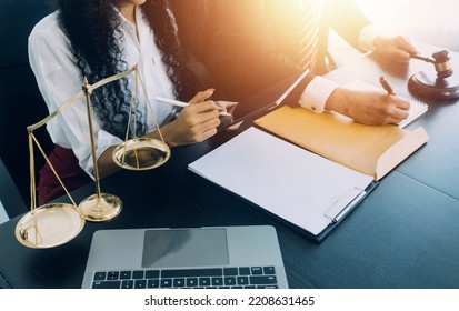 justice and law concept.Male judge in a courtroom on wooden table and Counselor or Male lawyer working in office. Legal law, advice and justice concept. - Shutterstock ID 2208631465