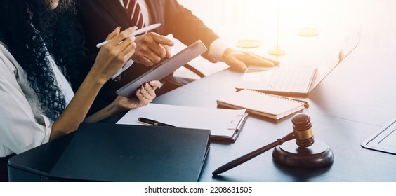 justice and law concept.Male judge in a courtroom on wooden table and Counselor or Male lawyer working in office. Legal law, advice and justice concept. - Shutterstock ID 2208631505