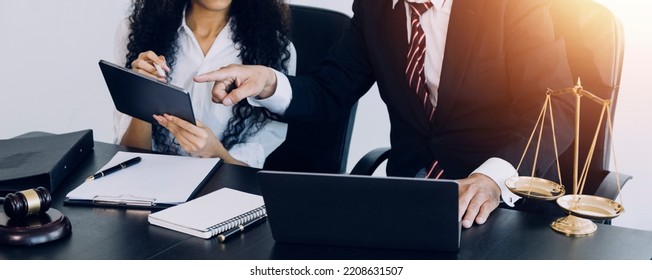justice and law concept.Male judge in a courtroom on wooden table and Counselor or Male lawyer working in office. Legal law, advice and justice concept. - Shutterstock ID 2208631507
