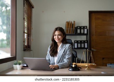 justice and law concept.Male judge in a courtroom on wooden table and Counselor or Portrait asian lawyer working with lsptop in office. Legal law, advice and justice concept - Shutterstock ID 2231185305