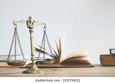 Justice Legal And Jurisprudence Concept. Law Books On Lawyer Desk At Law Firm.