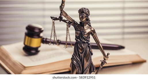 Justice Statue With Gavel On A Open Law Book 