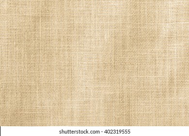 Jute hessian sackcloth woven organic burlap, hemp flax texture pattern background in yellow beige cream brown color