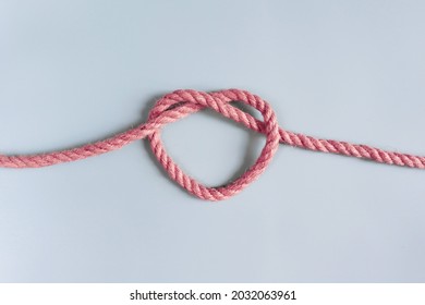 A Jute Rope Tied In The Shape Of A Heart. A Symbol Of Connection, Love, A Bond. The Concept Of A Strong Relationship. A Heart-shaped Knot.