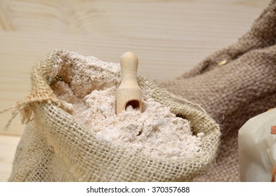 Jute Sack Of Whole Grain Flour With Wooden Vintage Spoon