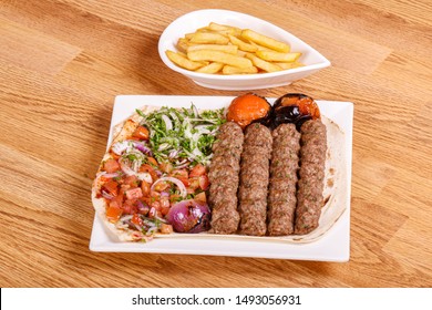 Kabab, Shish Kabab, Grilled Kabab With French Fries Styled And Garnished On White Plate