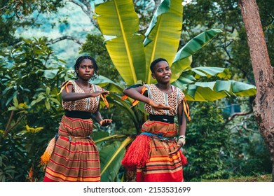 Kabarole, Uganda - January 2, 2022: Young African Women In Traditional Dress, Dancing Batwa Tribe Dance Outdoors In The Forest