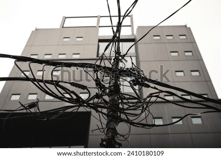 Kabel di tiang jalanan Jakarta, Tangled cables on Jakarta's street.