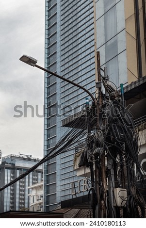 Kabel di tiang jalanan Jakarta, Tangled cables on Jakarta's street.