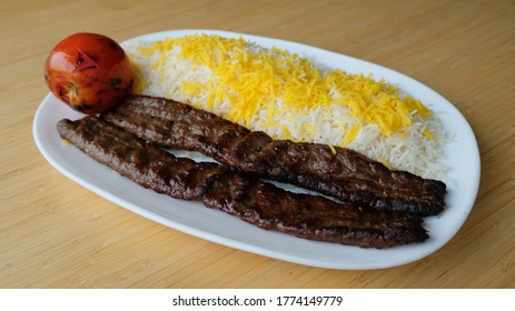 Kabob Kubideh - Two Skewers Of Ground Beef Served With Seasoned And Flame Broiled With Grilled Tomatoes And Basmati Rice