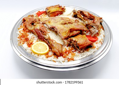 Kabsa is a mixed rice dish that originates from Saudi Arabia but is commonly regarded as a national dish in many Arab states of the Persian Gulf. The dish is made with rice and meat - Shutterstock ID 1782199361