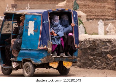 Kabul, Afghanistan April 2004: Afghan Women In Burqas Ride In The Back Of A Taxi (