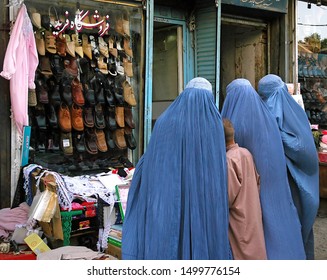 Kabul / Afghanistan - Aug 16 2005. Afghan Women Standing Outside A Shoe Store In Kabul, Afghanistan. The Women Are Wearing Blue Burqas (burkas). The Blue Burqa (burka) Is Traditional In Afghanistan.