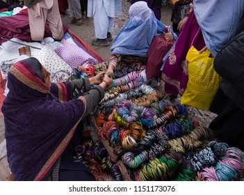 Kabul, Afghanistan, March 2005: Woman Looking At Bracelets In Kabul Market Stall