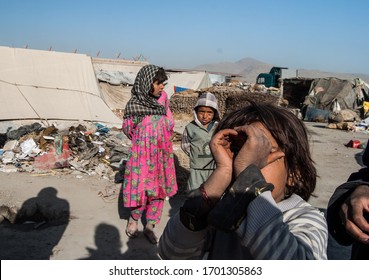 Kabul, Afghanistan, May 2019: Kuchi - Or Kochi - Children Inquisitively Crowd Around Westerners Visiting Their Nomadic Camp.