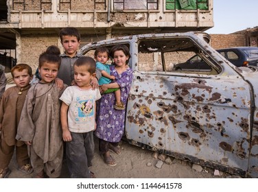 Kabul, Afghanistan September 2004: Children Play Around Bullet-riddled Car In Kabul