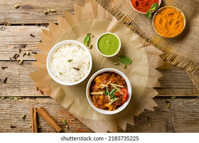 Kadai Chicken Indian Food Or Indian Curry With Mint Sauce On Wooden Background Top View