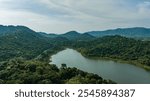 Kaeng Krachan dam with lake view and many green moutain, blue sky background. Kaeng Krachan Dam national park, Phetchaburi province, Thailand in aerial view from drone.