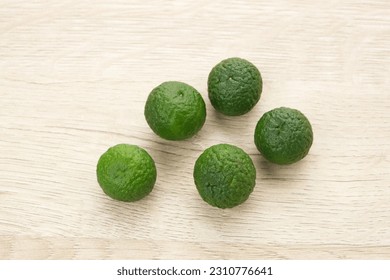 Kaffir Lime or Jeruk Limau on wooden table, food ingredient
 - Shutterstock ID 2310776641