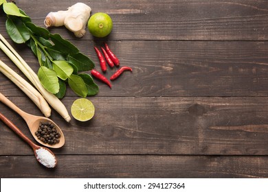 Kaffir Lime Leaves, Ginger, Lemon, Pepper, Salt,  Red Chilli And Green Onions On Wooden Background. Overhead View.
