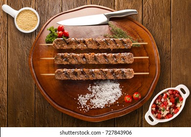 Kafta Steak Skewers On Top Of A Board