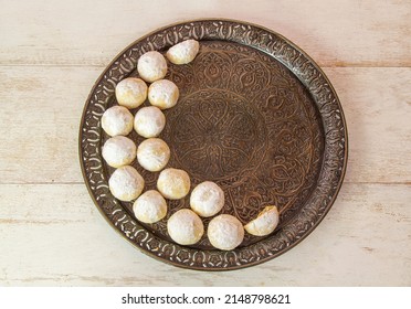 Kahk El Eid -  Cookies of Eid El Fitr Islamic Feast on vintage tray arranged in a crescent moon shape , ready for Feast celebration.