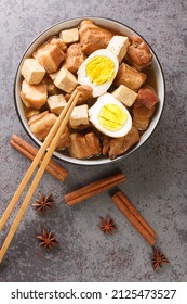 Kai Palo Thai Home Style Recipe For Pork And Egg Stew Spiced With Cinnamon And Star Anise Closeup In The Bowl On The Table. Vertical Top View From Above
