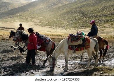 Kailash area Tibet China - 06 23 2008: Tibetans pilgrims with horses during the second day of ritual kora around sacred Mount Kailash. Ngari scenery in West Tibet. Sacred place for Buddha pupils